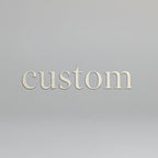 Ceramic bowl with a speckled purple and brown design on a stone surface.